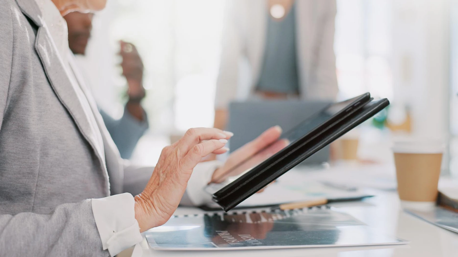 Hands tablet and senior woman in meeting researching internet browsing or networking Technology planning or elderly female em
