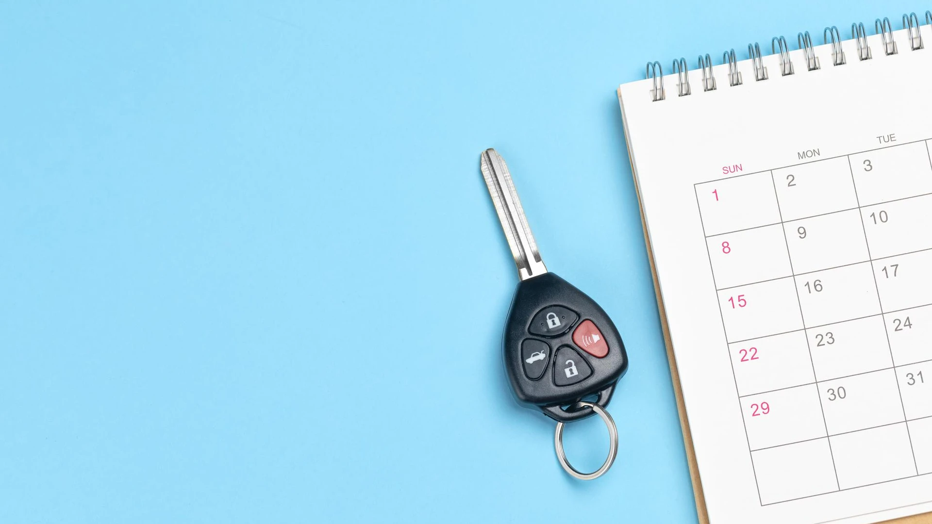 Car keys and calendar on a blue background Template Copy space for text